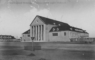 Black and white photo of a large building with roman columns